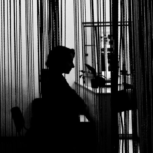 Silhouette of a person meditating in a quiet, minimalist room.